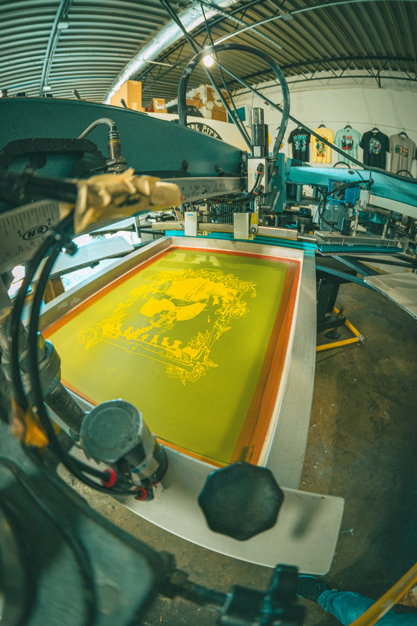 Yellow ink detail on a screen printing machine